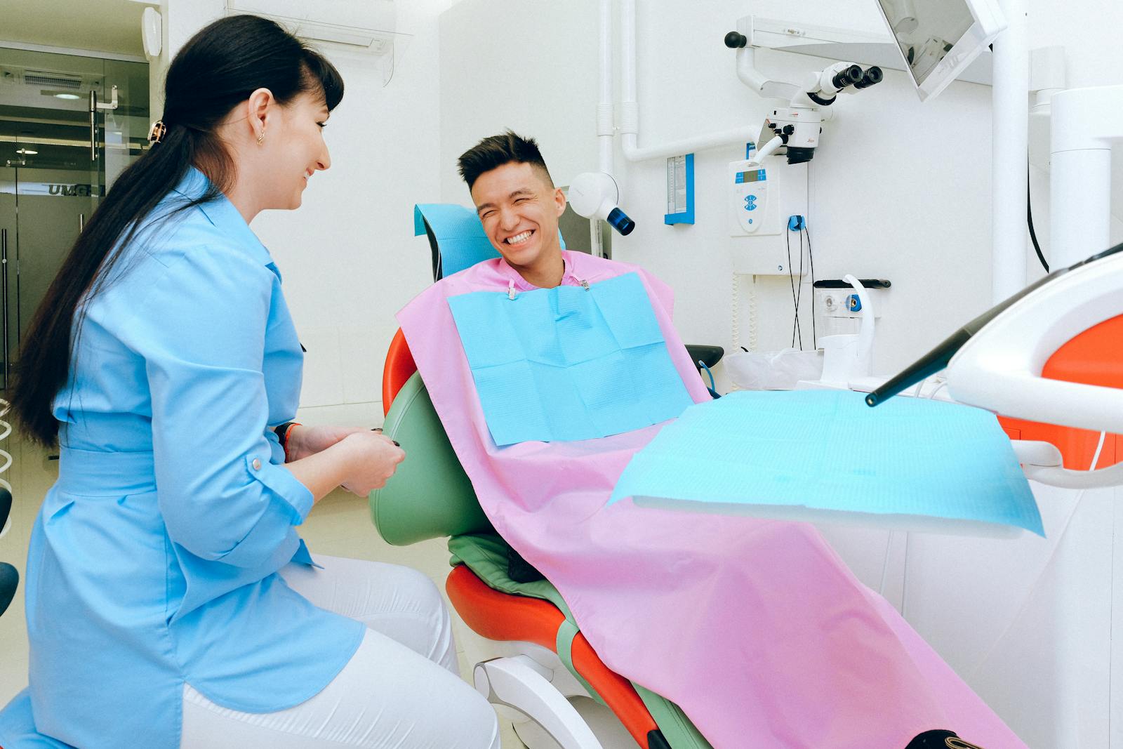 A relaxed, smiling patient and dentist sharing an easy moment at Empire Dental
